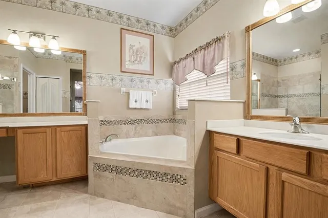 a bathroom with a double vanity sink mirror and shower
