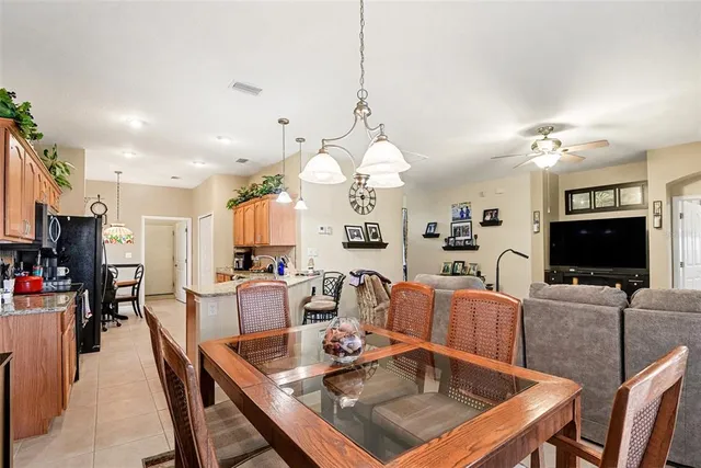 a living room with furniture a flat screen tv and kitchen view