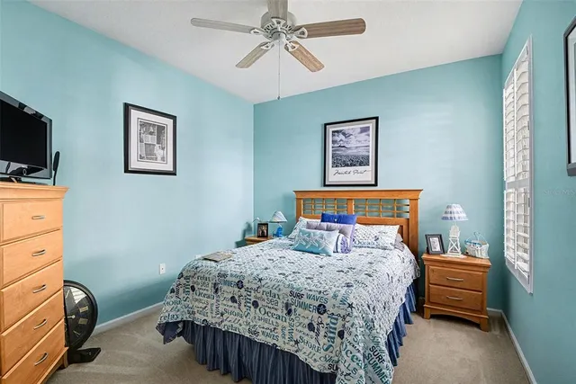 a bedroom with a bed and a tv on wall