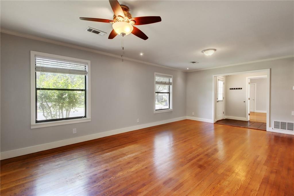 1408 Ruth Avenue Austin, TX 78757 - Photo 12 of 33 a view of an empty room with wooden floor and a window