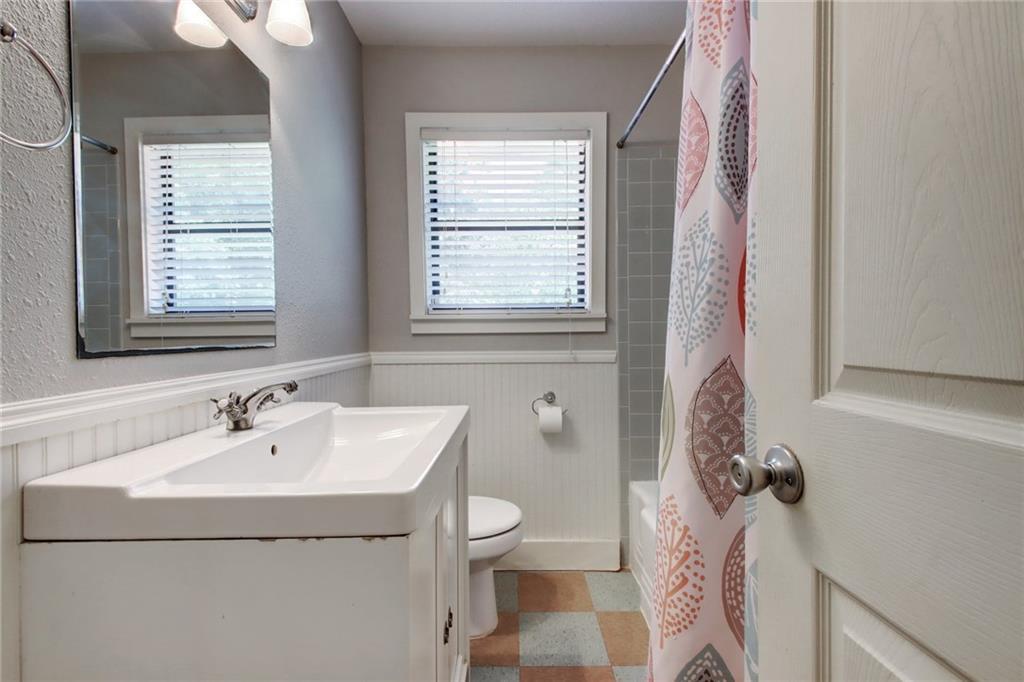 1408 Ruth Avenue Austin, TX 78757 - Photo 14 of 33 a bathroom with a sink a toilet and shower curtain
