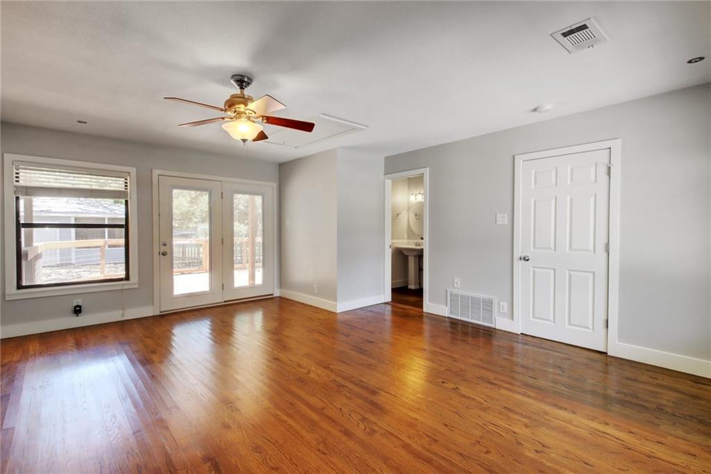 1408 Ruth Avenue Austin, TX 78757 - Photo 16 of 33 a view of an empty room with wooden floor and a window