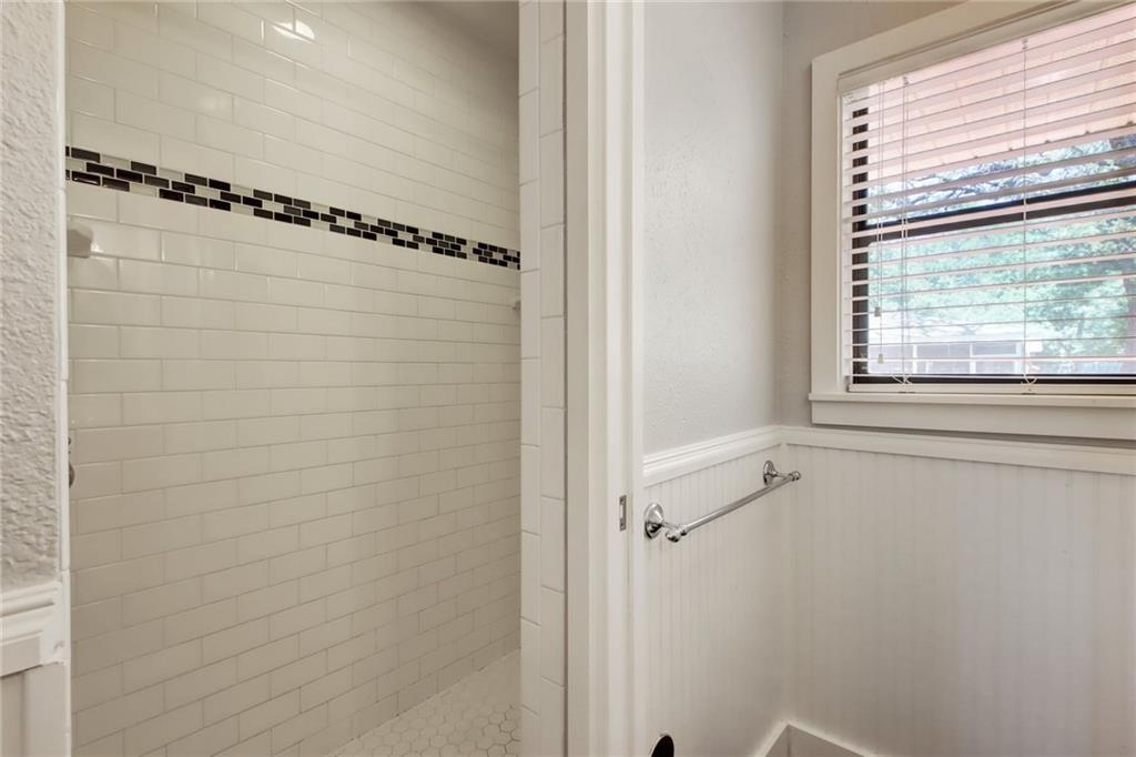 1408 Ruth Avenue Austin, TX 78757 - Photo 18 of 33 a bathroom with a window a shower and a glass door