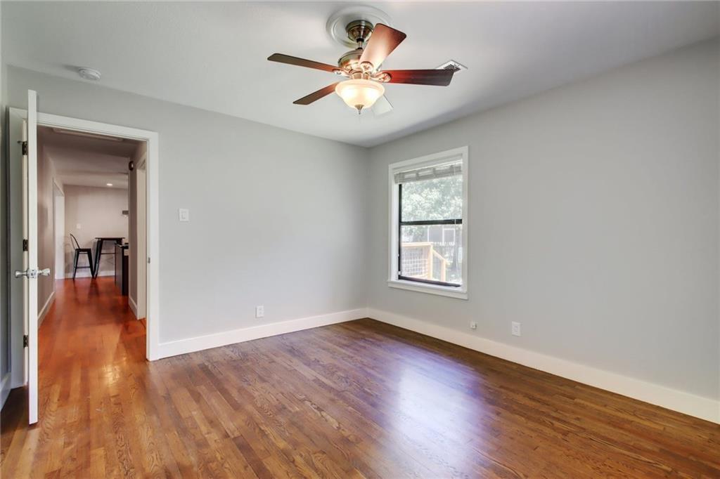 1408 Ruth Avenue Austin, TX 78757 - Photo 19 of 33 a view of an empty room with window and wooden floor