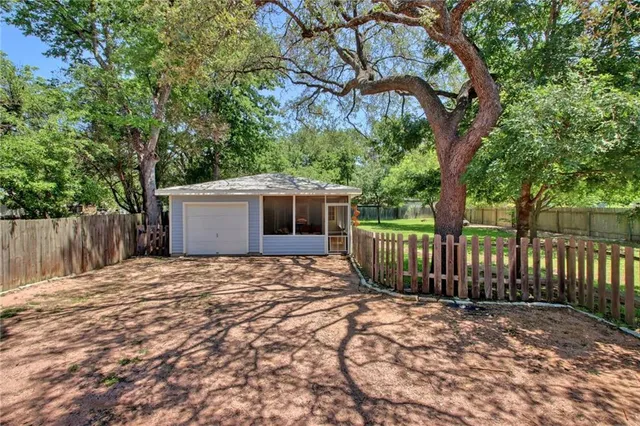 a view of balcony with wooden floor and fence