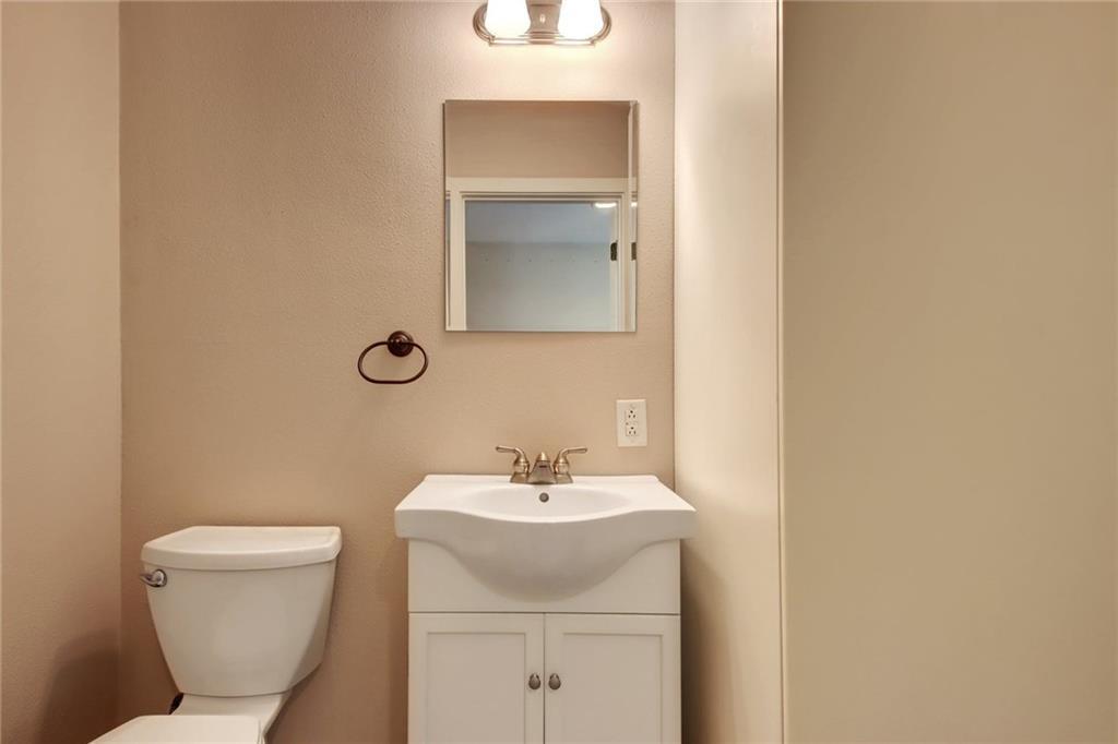 1408 Ruth Avenue Austin, TX 78757 - Photo 26 of 33 a bathroom with a toilet sink and mirror