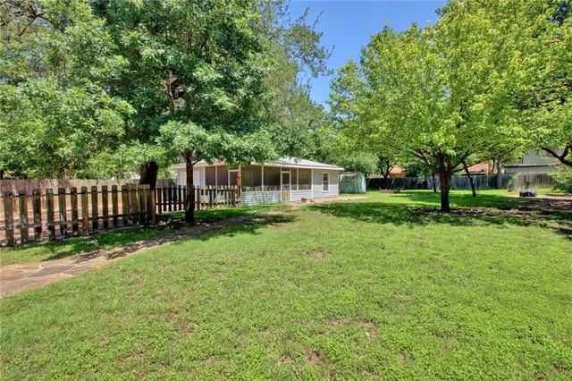 a view of a house with a backyard