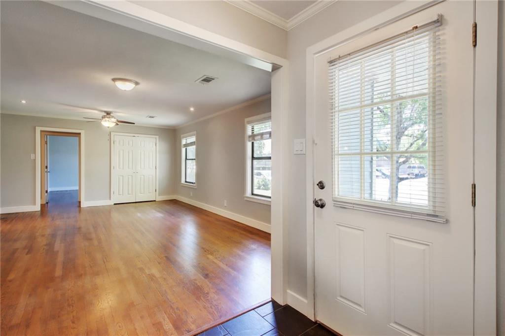 1408 Ruth Avenue Austin, TX 78757 - Photo 3 of 33 a view of an empty room with wooden floor and a window