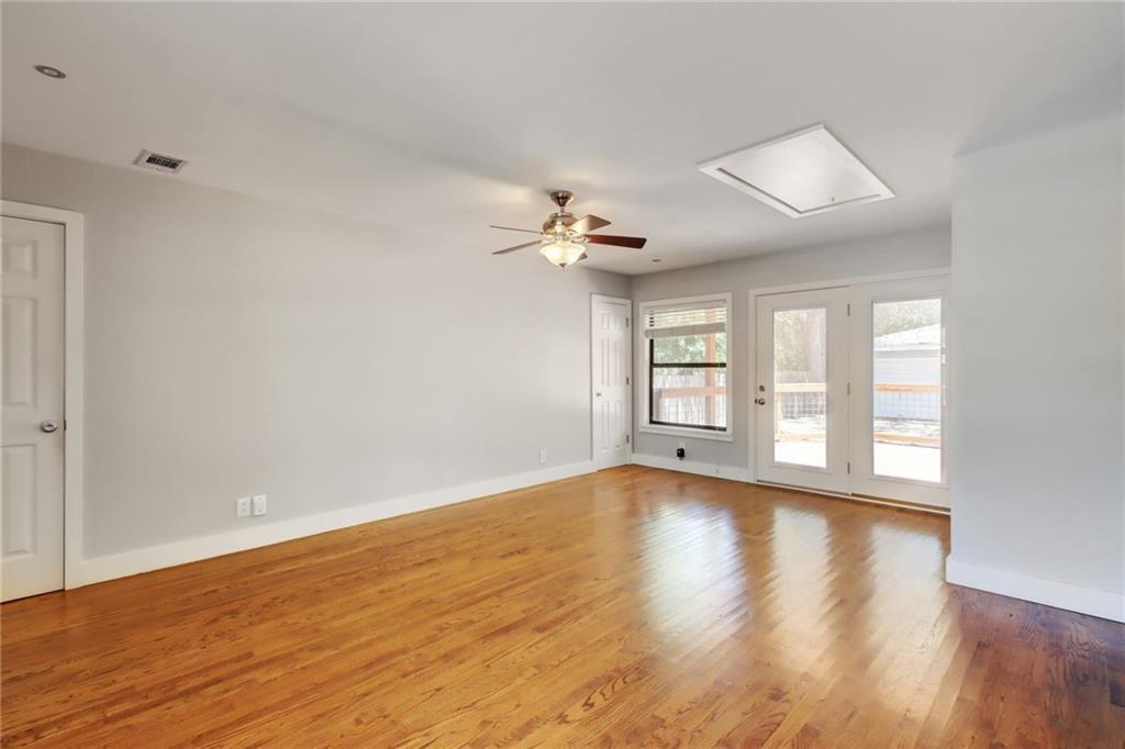 1408 Ruth Avenue Austin, TX 78757 - Photo 4 of 33 a view of an empty room with wooden floor and a window