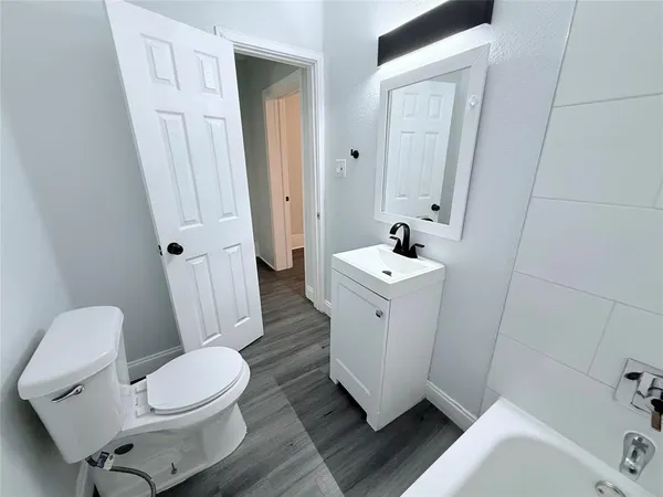 a white toilet sitting next to a bathroom sink