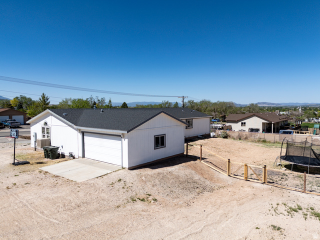 1637 East Midvalley Road Enoch, UT 84721 - Photo 2 of 48 White siding exterior with a dark shingle roof and an attached garage