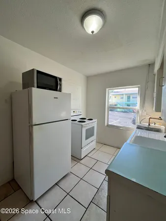 a kitchen with cabinets and white appliances