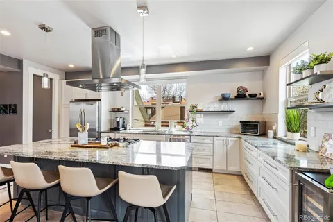 a kitchen with cabinets and chairs