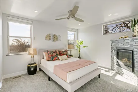 a bedroom with a bed and a fireplace