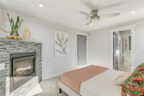 a bedroom with a bed and a fireplace