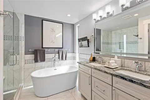 a bathroom with a tub sink and mirror