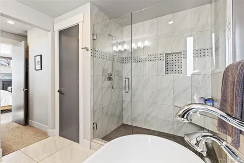 a bathroom with a sink a toilet a mirror and shower