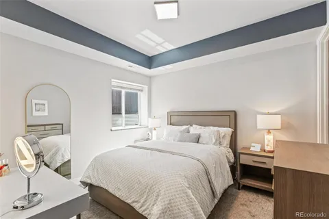 a bedroom with a bed and a night stand