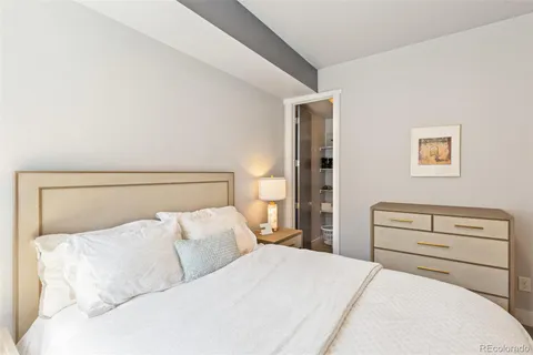 a bedroom with a bed and walk in closet