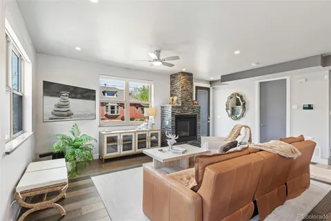 a living room with furniture a fireplace and a flat screen tv