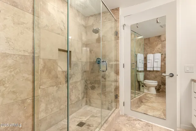 a bathroom with a glass shower door
