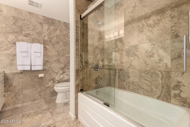 a bathroom with a bathtub and a toilet