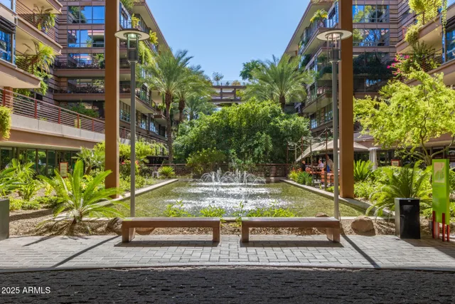 a view of a street with potted plants