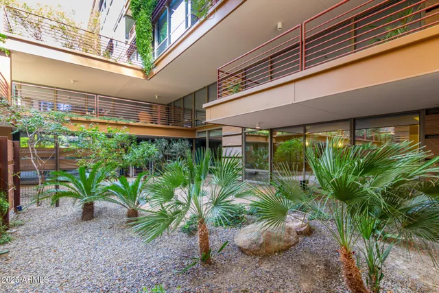 a living room with couch and a table with wooden floor