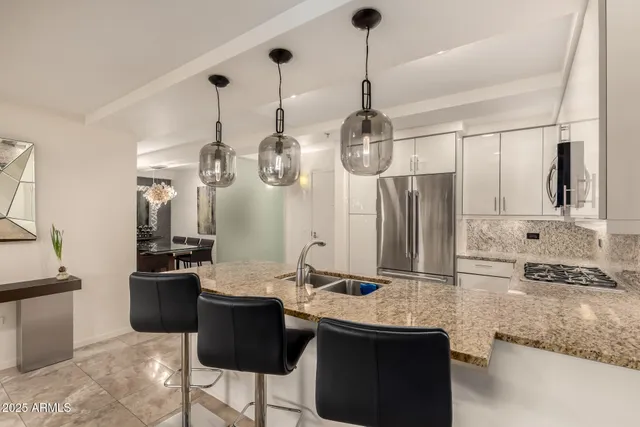 a kitchen with stainless steel appliances granite countertop a sink and cabinets