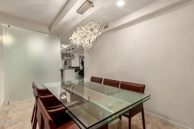 a view of a dining room with furniture and chandelier