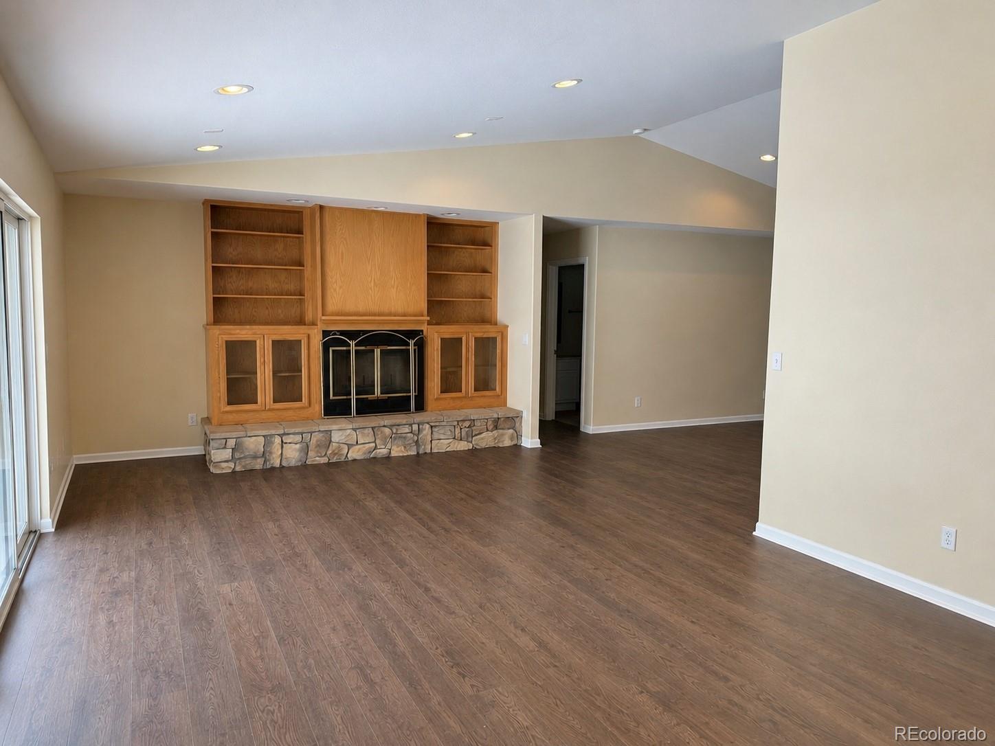 29469 County Road Fort Garland, CO 81133 - Photo 8 of 36 an empty room with wooden floor fireplace and windows