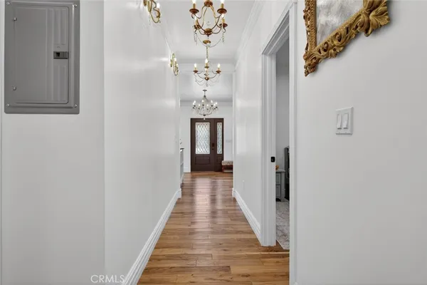 a view of a hallway with wooden floor and staircase