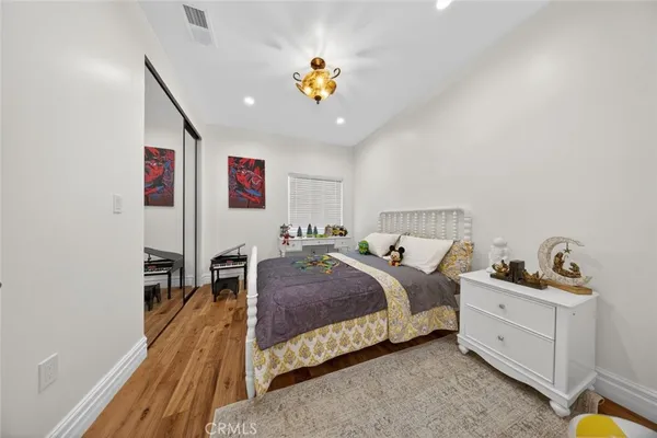 a spacious bedroom with a bed and a chandelier