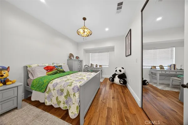 a bed room with a bed and a chandelier