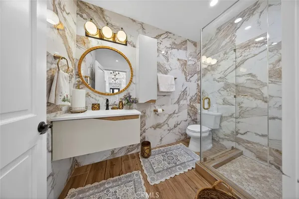 a bathroom with a sink mirror and vanity