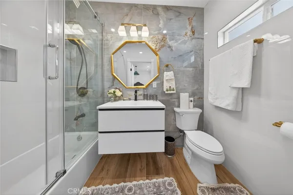 a bathroom with a toilet a sink and a mirror