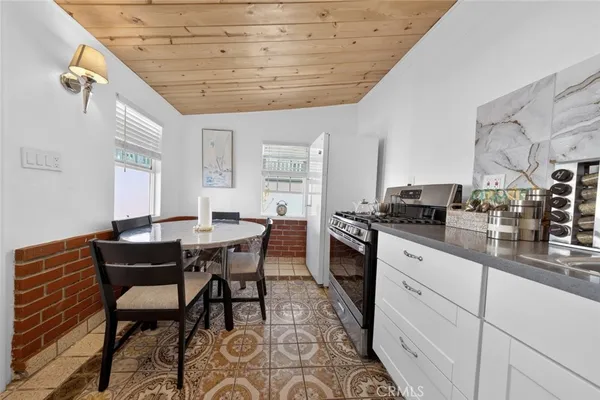 a kitchen with a table chairs stove and cabinets