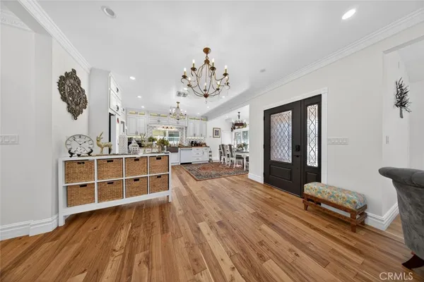 a view of a living room and bathroom with wooden floor