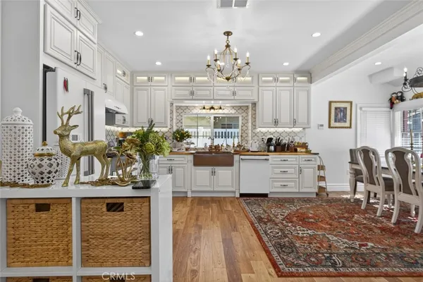 a kitchen with stainless steel appliances granite countertop a stove a sink and a dining table