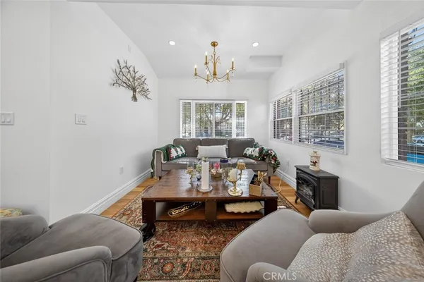 a living room with furniture windows and a chandelier