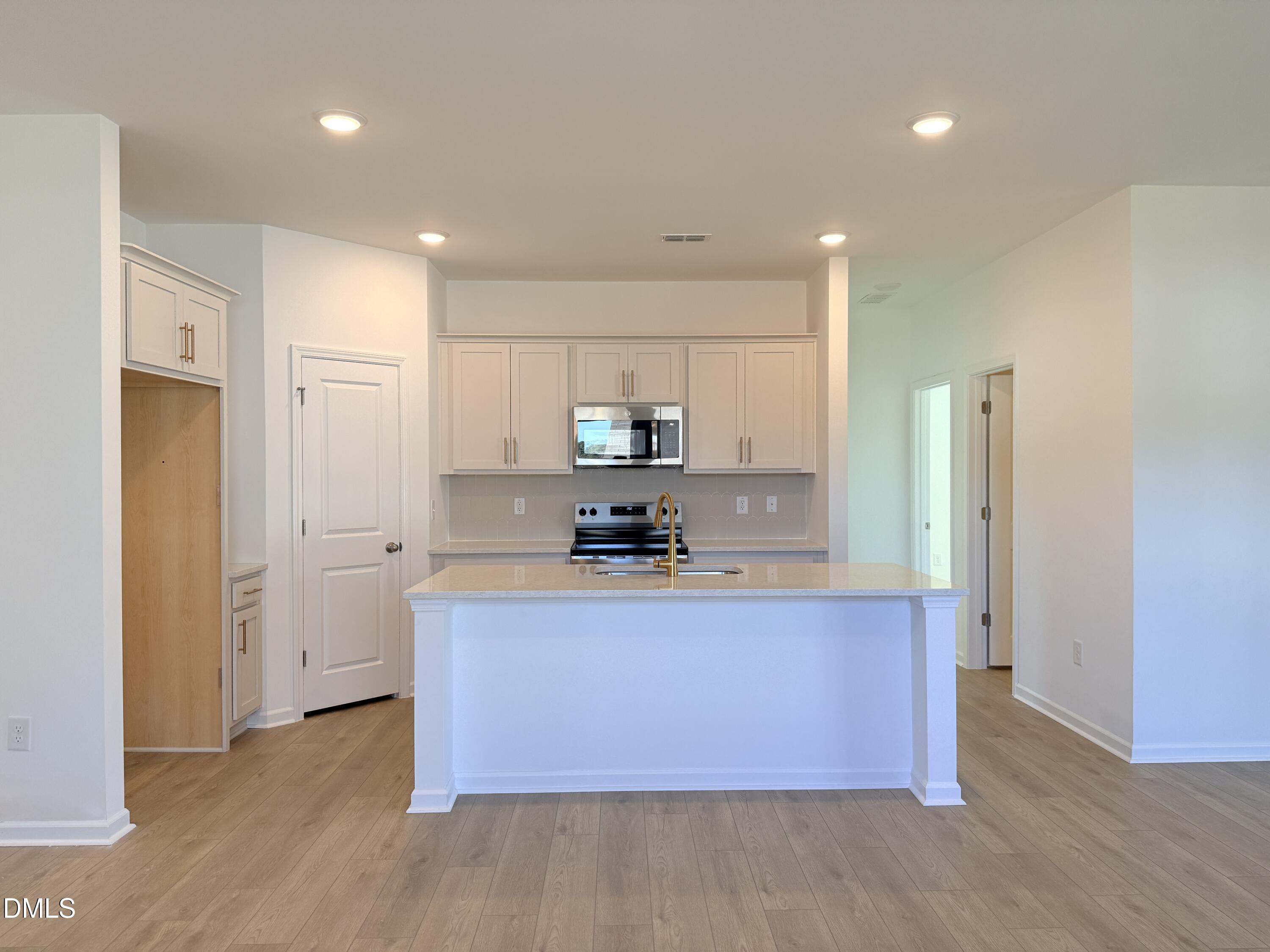 11804 Salers Loop Middlesex, NC 27557 - Photo 11 of 31 a kitchen with stainless steel appliances granite countertop a sink a refrigerator and a stove