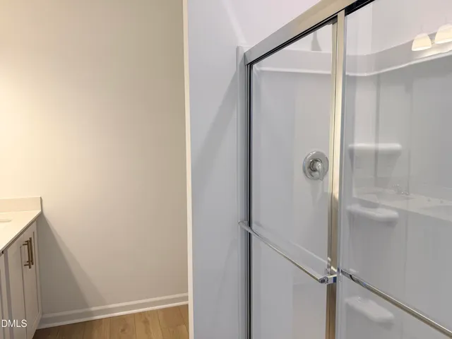 a bathroom with a glass shower door