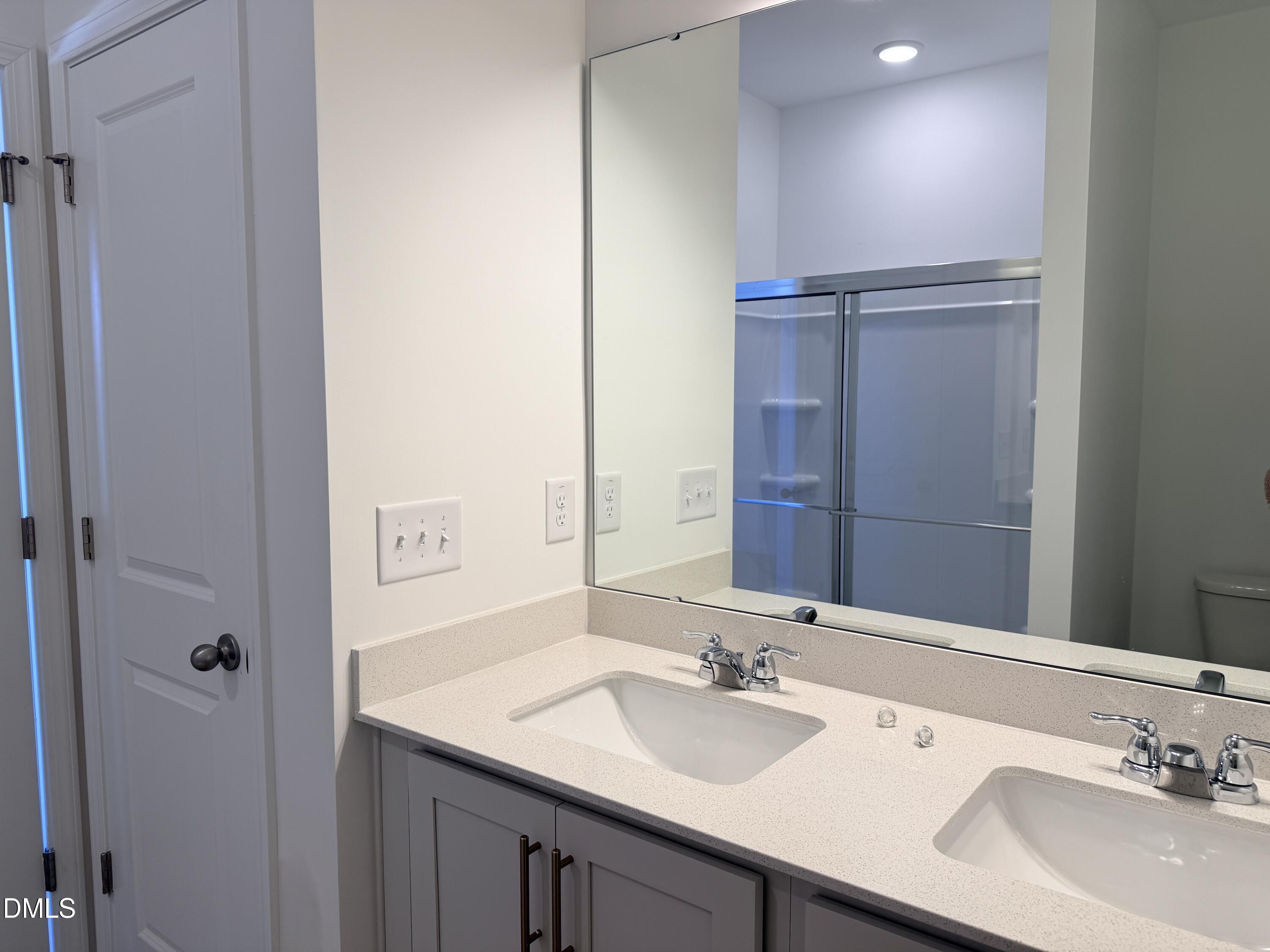 11804 Salers Loop Middlesex, NC 27557 - Photo 20 of 31 a bathroom with a granite countertop sink and a mirror
