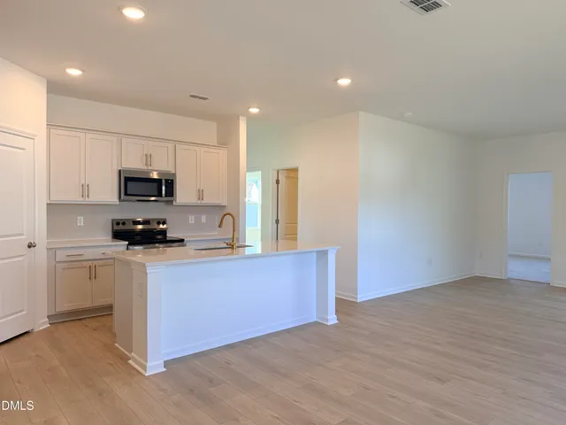 a kitchen with granite countertop a stove and a refrigerator