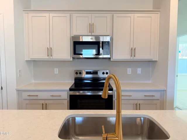 a kitchen with stainless steel appliances granite countertop a sink and a cabinets