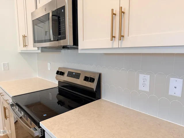a kitchen with wooden cabinets and a stove top oven