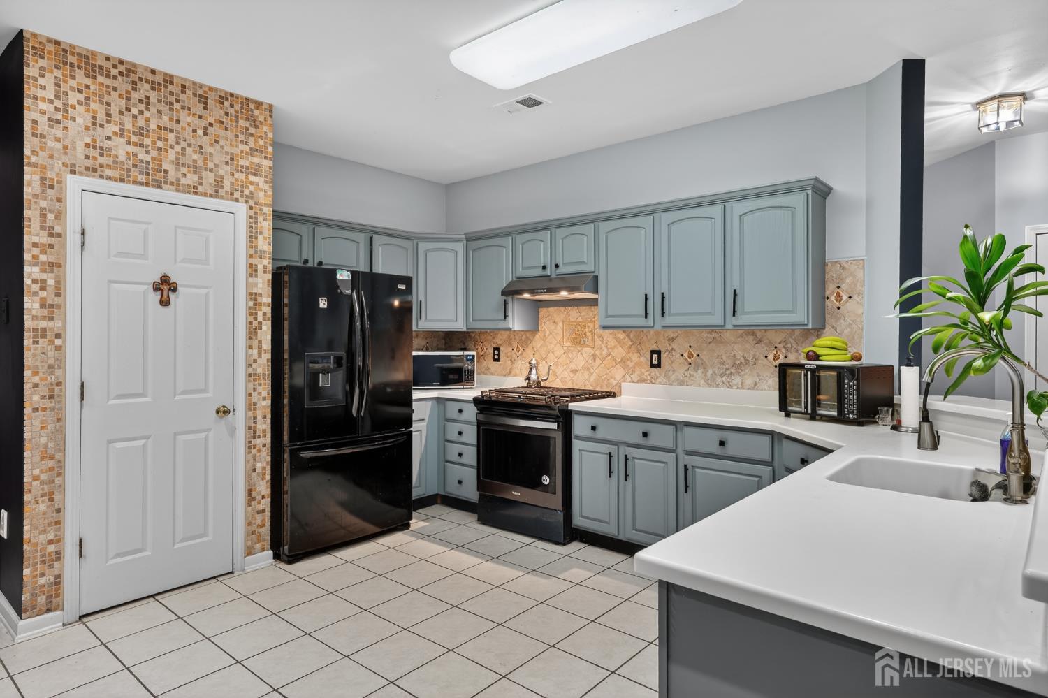 351 Wedgewood Road Morganville, NJ 07751 - Photo 41 of 74 a kitchen with a refrigerator and cabinets