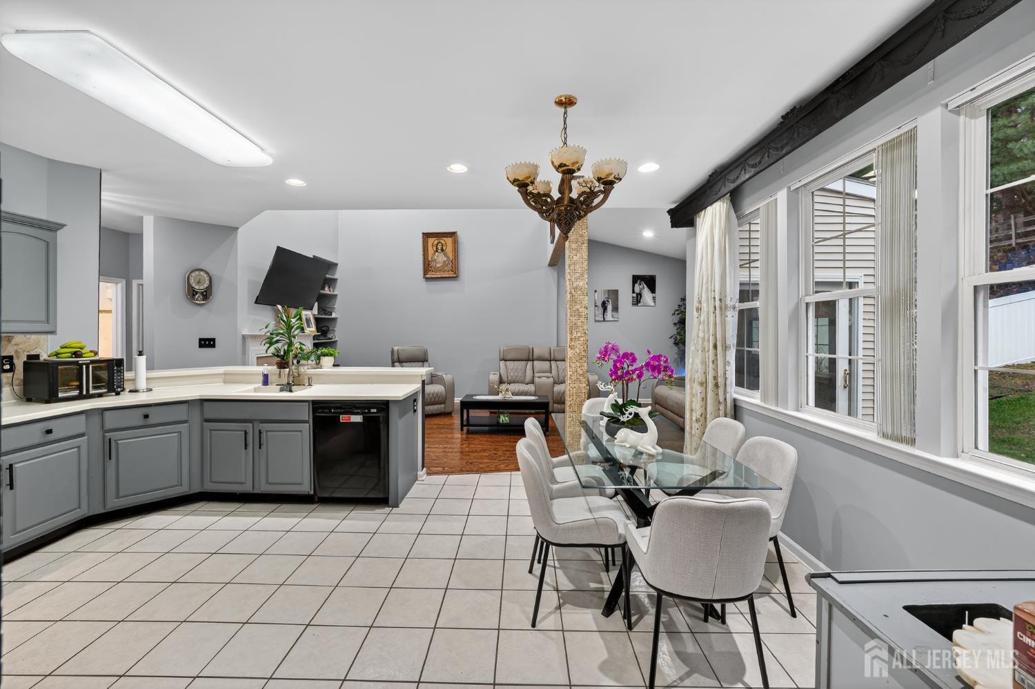 351 Wedgewood Road Morganville, NJ 07751 - Photo 47 of 74 a kitchen with a dining table chairs stainless steel appliances and cabinets