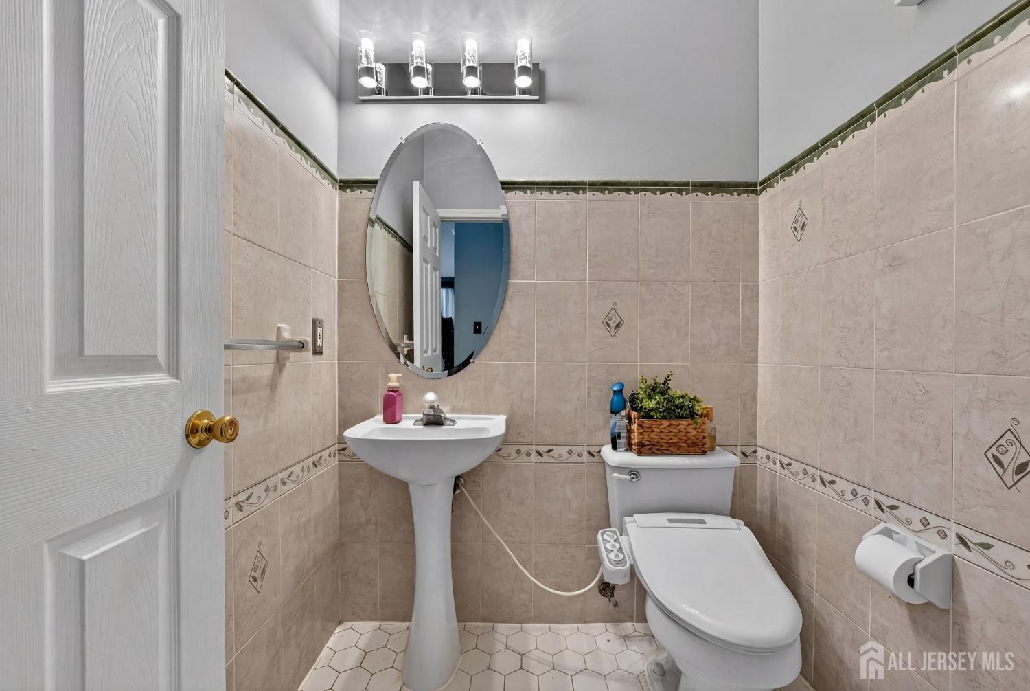 351 Wedgewood Road Morganville, NJ 07751 - Photo 57 of 74 a bathroom with a sink a mirror a toilet and shower