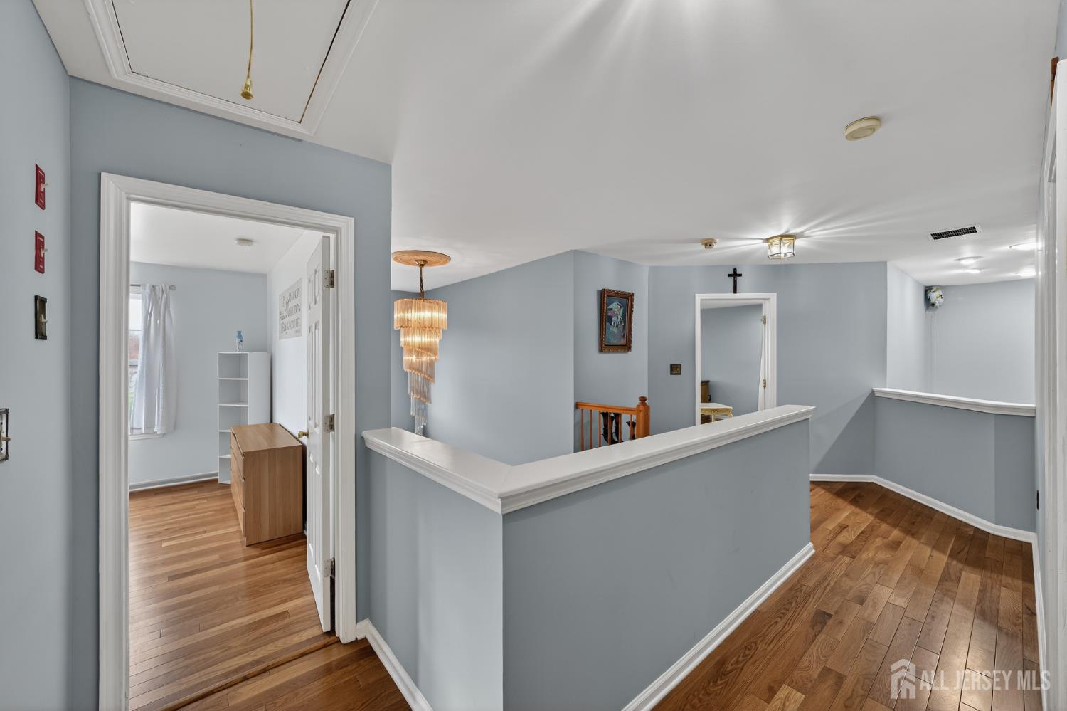 351 Wedgewood Road Morganville, NJ 07751 - Photo 59 of 74 a view of a hallway with dining room and wooden floor